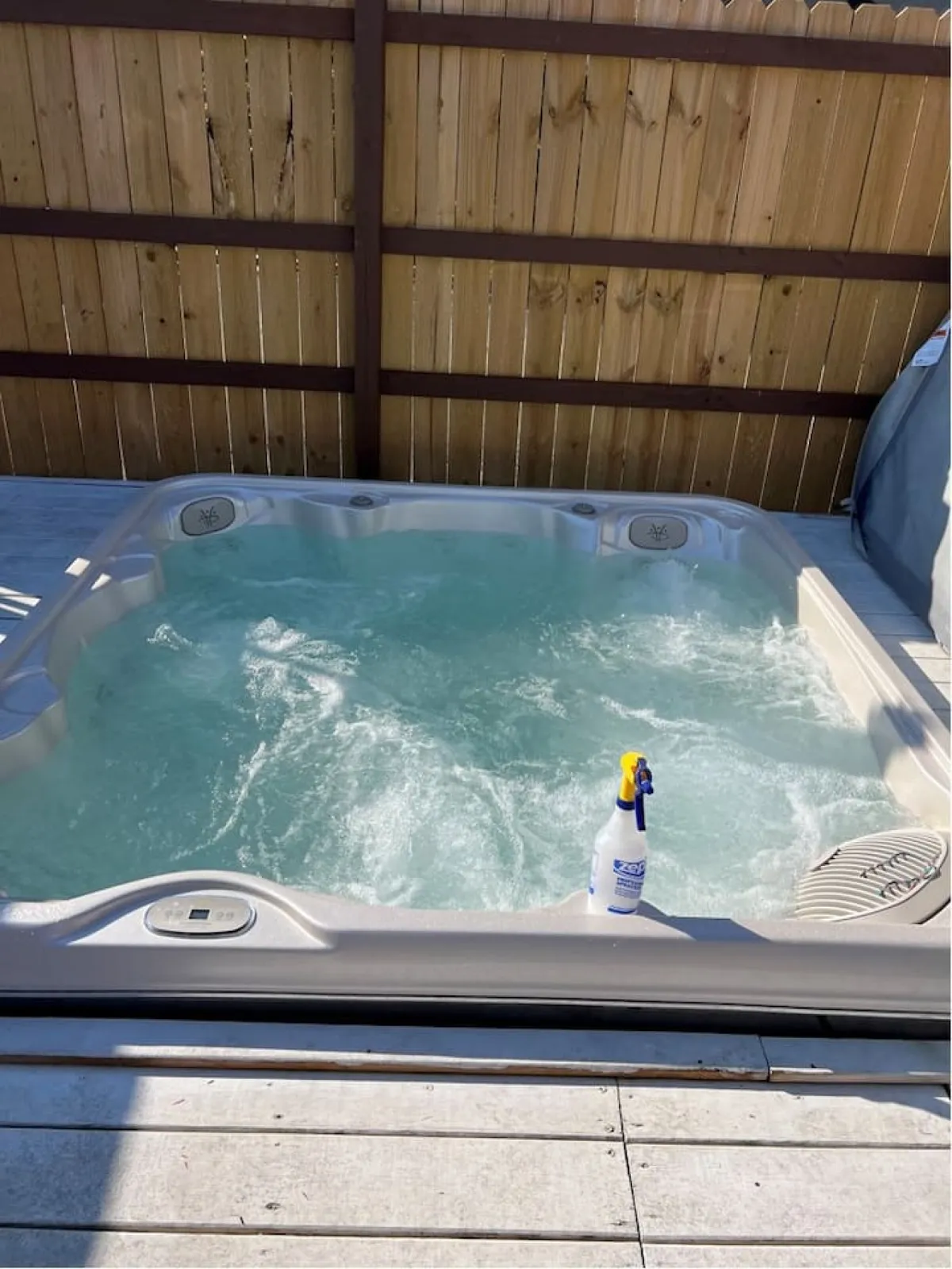 An inviting hot tub set in a tranquil space, with clear water and a sense of privacy. The hot tub environment suggests relaxation and comfort, ideal for unwinding after a day of activity.